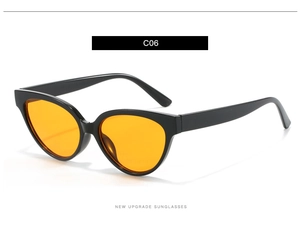 Close-up of black cat-eye sunglasses featuring vibrant orange lenses and high-quality frames