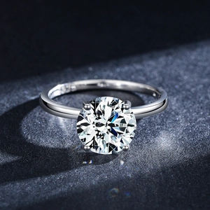 Classic S925 sterling silver four-claw crown ring with round cubic zirconia on blue background
