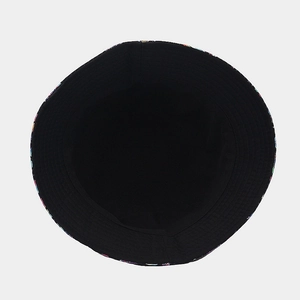 Reversible bucket hat with mushroom pattern and solid black fabric shown from above