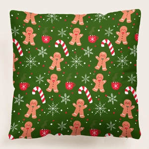 Detalle de funda de cojín navideña verde oscuro con estampado de jengibre y bastones dulces