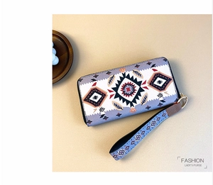 Close-up of long zip wallet with ethnic geometric patterns and stylish blue wrist strap