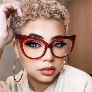 Close-up of red glitter cat eye glasses frame on a model featuring a stylish oversized design