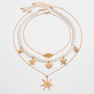 Three-piece layered gold necklace with imitation pearls and starfish shell pendants