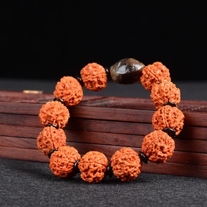 5-petals Nepal Rudraksha seed bracelet with black spacers and agate bead on wood box