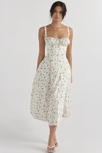 Detail of floral summer strap dress showing drawstring pleated chest and cotton texture