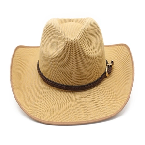 Detailed close-up of woven straw cowboy hat texture with dark brown decorative leather belt