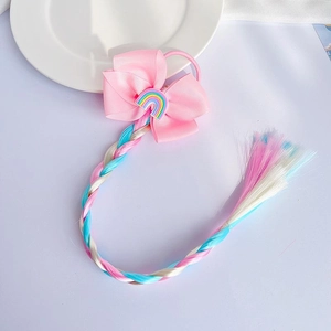 Kids hair accessory with pink bow, rainbow charm, and colorful braided hair extension
