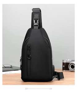 Detail of waterproof crossbody bag featuring a USB charging port and vertical zipper