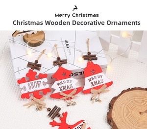 Close-up of wooden Christmas ornaments with snowflakes, bells, and deer motifs on a white surface