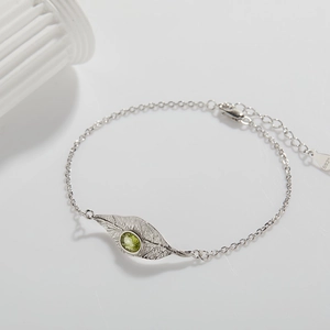 S925 sterling silver leaf bracelet detail featuring a green peridot gemstone inlay