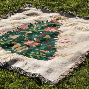 Detailed macro view of festive Christmas tree knit throw blanket with decorative tassels