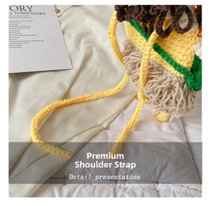 Detail of hand-knitted hamburger bag featuring a thick yellow braided shoulder strap