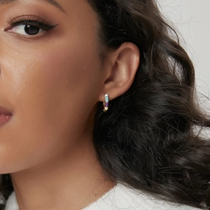 Colorful enamel bamboo joint hoop earrings in gold plating worn by a model