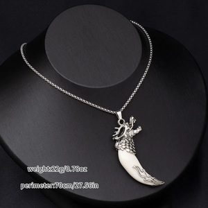Detail view of dragon head pendant with white tusk on 70cm chain, weight 22g