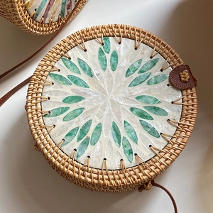 Handcrafted round rattan shell bag with green and white floral inlay and leather strap