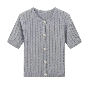 Detailed view of grey cable-knit short sleeve cardigan with embossed silver buttons