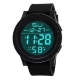 Close-up of black digital sports watch showing green LED time and date on circular dial