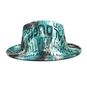 Detailed view of the graffiti print pattern and tie-dye texture on the wide brim felt hat