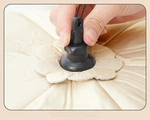 Close-up of insulated food cover showing the one-touch folding mechanism and satin fabric