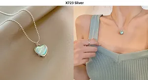 Detail of heart pendant necklace with mint green opal inlay on a silver bead chain