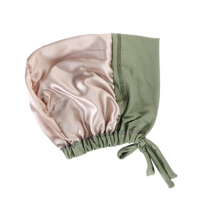 Detail of satin lining and knit fabric on two-tone sleep cap with adjustable tie