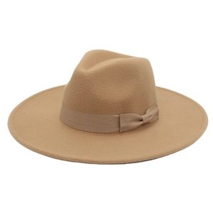 Detail of camel wool fedora hat featuring wide brim and matching grosgrain bow ribbon