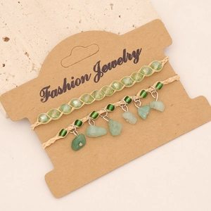 Detail of bohemian handmade braided bracelet set with green natural stones and beads