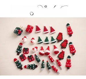 Flat lay of handmade wool felt Christmas tree, reindeer and gift box ornaments for DIY crafts