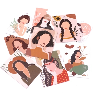 Flat lay of artistic earring display cards with abstract female portrait illustrations