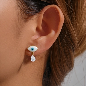 Macro shot of S925 silver evil eye stud earring with clear teardrop zircon pendant