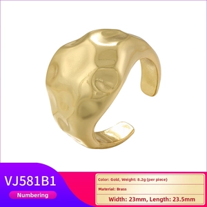 Detail of gold brass open ring with unique hammered texture and irregular fluid design