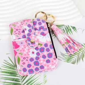 Pink floral PU leather card holder with zipper closure and a matching tassel charm detail