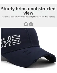 Detail of navy blue baseball cap showing white KS embroidery and distressed brim texture