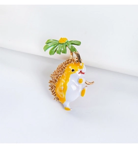 Detail of hedgehog brooch with green flower umbrella in enamel and gold finish