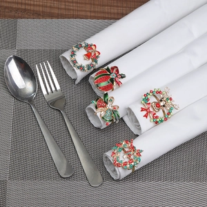 Christmas napkin rings set featuring metal reindeer, wreaths and bells with colorful rhinestones