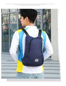 Close-up of lightweight navy blue folding backpack with VANAHEIMR logo and breathable mesh straps