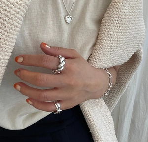 Minimalist silver jewelry set featuring twisted ring, star ring and heart necklace