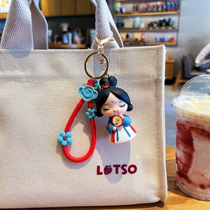 Cute Tang Dynasty doll keychain in blue Hanfu on a beige canvas bag strap