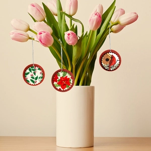 Round Christmas ornaments set with glitter edges and festive floral bird patterns