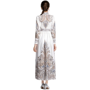 Back view of a long paisley print dress with puff sleeves and high waist in resort style