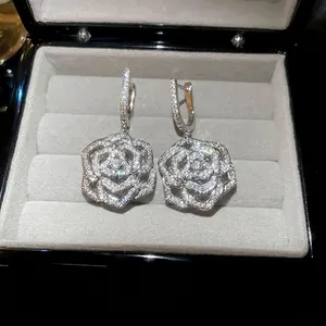 Luxury silver flower drop earrings with sparkling cubic zirconia on grey velvet box