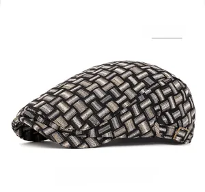 Detail of vintage plaid newsboy cap featuring black white and brown jacquard texture