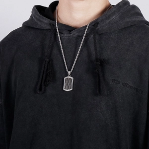 Close-up of men's silver stainless steel square pendant with woven texture and twist chain