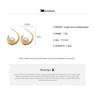 Detail view of C-shaped pearl earrings with cubic zirconia stones and 2*1.5cm dimensions