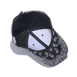 Inside view of black and white paisley hip-hop baseball cap showing inner lining and tags