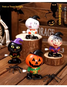 Detail of Halloween wind-up toys including pumpkin, cat, and ghost for party favors
