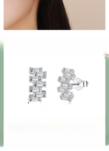 Macro detail of S925 sterling silver stud earrings with zirconia and size specifications