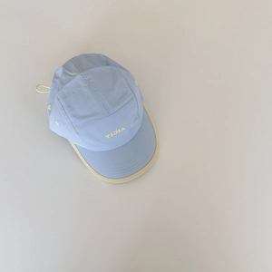 Detail view of quick-dry kids baseball cap with letter embroidery and contrast piping