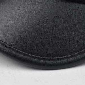 Macro detail of black lychee texture faux leather with precise edge stitching craftsmanship