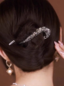Macro shot of silver hair pin with black rhinestones in a spiral woven structure